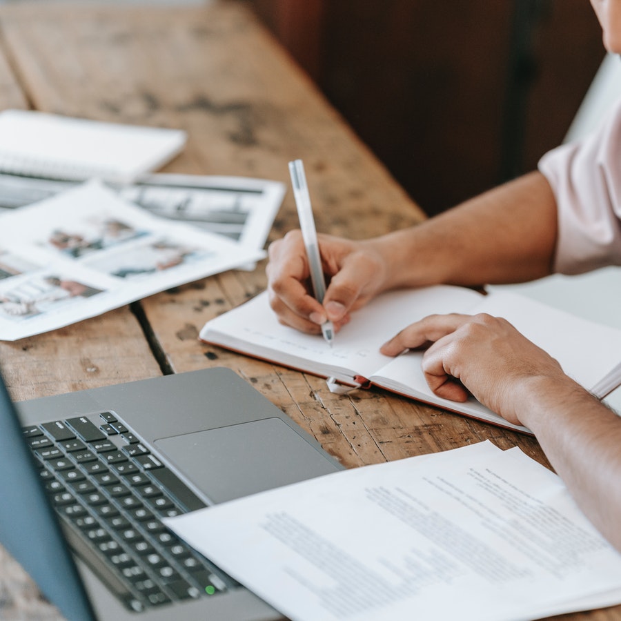 Student writing in notepad