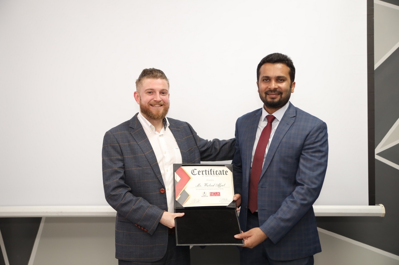 David Hodgson presenting Mr Waleed Afzal (Program Head Engineering) with his certificate of participation at Beaconhouse International College.