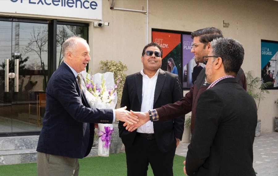 Staff members meeting outside institution