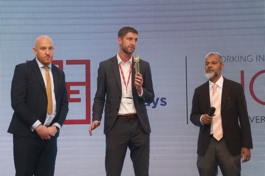 Staff on stage talking about the new partnership