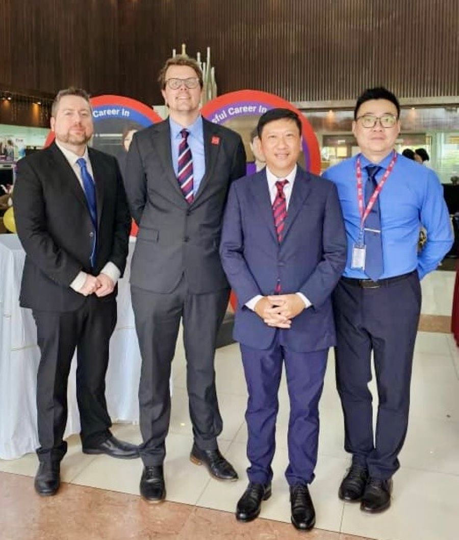 Staff posing at event.